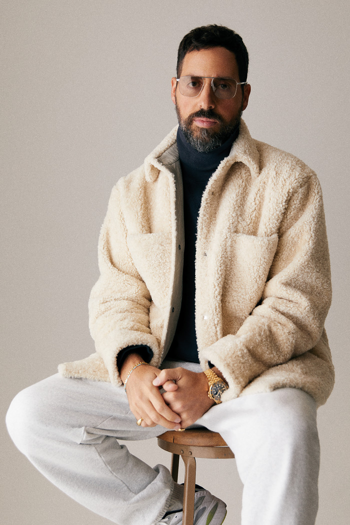 Ronnie Fieg seated while wearing a gold watch